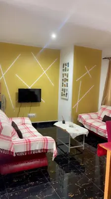 a living room with two couches and a tv at MeM Apartment in Praia