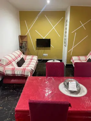 a room with two beds and a table with a cake at MeM Apartment in Praia