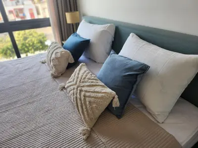 a bed with a bunch of pillows on it at Boa Mindelo Azul in Mindelo