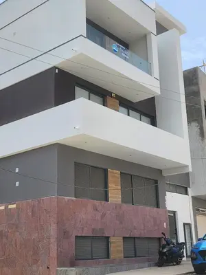 a building with a motorcycle parked in front of it at Boa Mindelo Azul in Mindelo