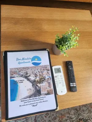 a book sitting on a table with a remote control at Boa Mindelo Azul in Mindelo