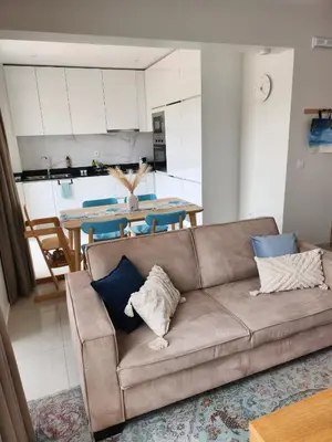a living room with a couch and a table at Boa Mindelo Azul in Mindelo