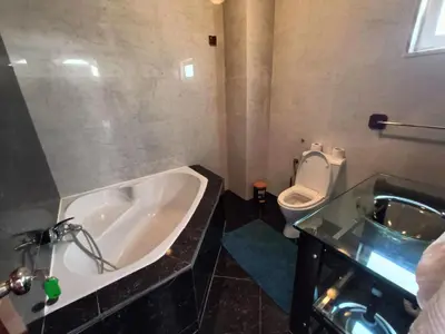 a bathroom with a bath tub and a toilet at Casa Miami in Tarrafal