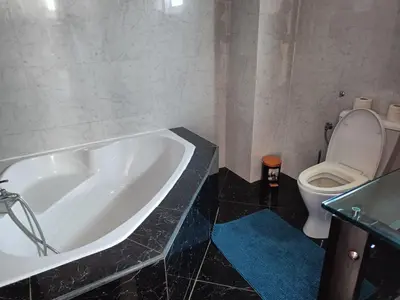 a bathroom with a bath tub and a toilet at Casa Miami in Tarrafal