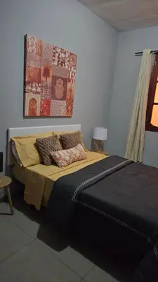 a bedroom with a large bed in a room at Palmarejo Cozy Retreat in Praia
