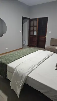 a large bedroom with two beds and a couch at Palmarejo Cozy Retreat in Praia