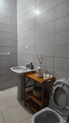 a bathroom with a sink and a toilet at Palmarejo Cozy Retreat in Praia