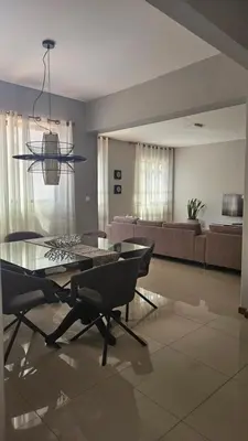 a living room with a glass table and chairs at Palmarejo Cozy Retreat in Praia