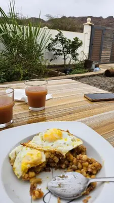 a plate of food with eggs and beans on a table at Serene Escape in Porto Madeira in Sacramento