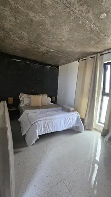 a bedroom with a large bed with a large window at Serene Escape in Porto Madeira in Sacramento