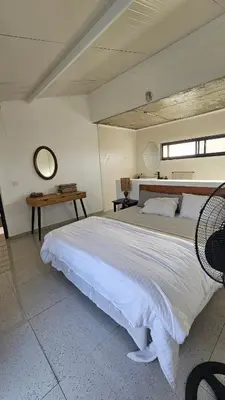 a bedroom with a large bed and a mirror at Serene Escape in Porto Madeira in Sacramento