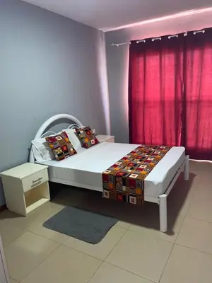 a bedroom with a bed and a red curtain at KÁ Rui in Santa Maria