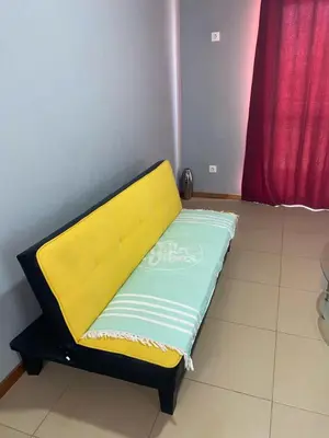 a yellow and green bed in a room at KÁ Rui in Santa Maria