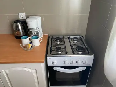 a kitchen with a stove and a counter with cups at KÁ Rui in Santa Maria