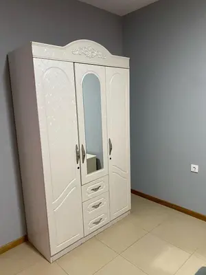 a white cabinet with a mirror in a room at KÁ Rui in Santa Maria