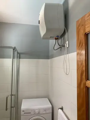 a small bathroom with a toilet and a shower at KÁ Rui in Santa Maria