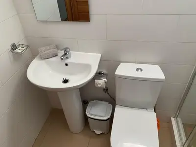a white bathroom with a sink and a toilet at KÁ Rui in Santa Maria