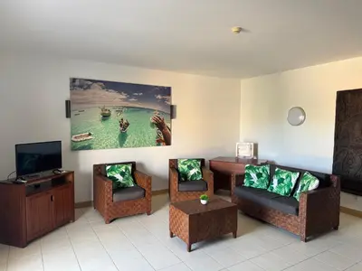 a living room with three chairs and a tv at BEACH HOUSE - Walkable to Beach - Wi-Fi Included in Santa Maria