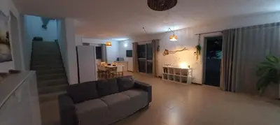 a living room with a couch and a staircase at Casa Estoril, Boa Vista in Sal Rei
