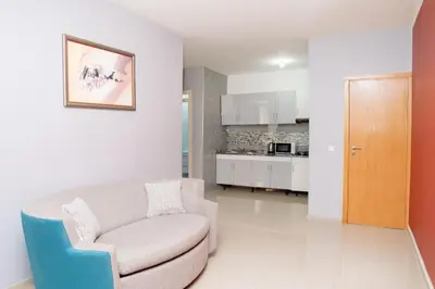 a living room with a couch and a kitchen at J Martins Apart T11 Tarrafal in Tarrafal