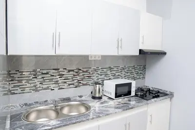 a kitchen counter with a sink and a microwave at J Martins Apart T11 Tarrafal in Tarrafal