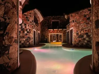 an indoor swimming pool in a building with lights at Suite and pool, Praia Estoril, Sal Rei in Sal Rei