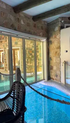 a hammock in a room with a swimming pool at Suite and pool, Praia Estoril, Sal Rei in Sal Rei
