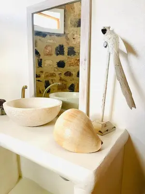 a bathroom counter with a bowl and a mirror at Suite and pool, Praia Estoril, Sal Rei in Sal Rei