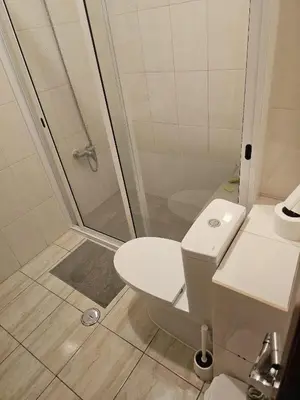 a bathroom with a shower and a toilet and a sink at Conforto de um Lar in Ponta do Sol