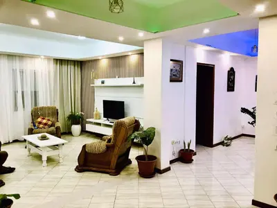 a living room with two chairs and a fireplace at Conforto de um Lar in Ponta do Sol