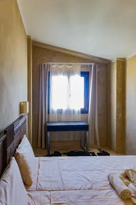 a bedroom with a bed and a window with a desk at Aparthotel Tropical Bounty Beach T3 in Santa Maria