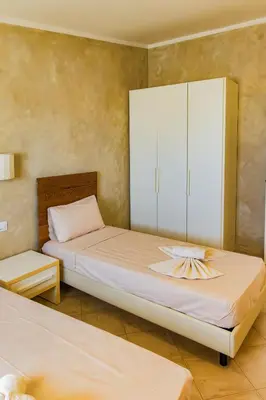 a bedroom with two beds and a white cabinet at Aparthotel Tropical Bounty Beach T3 in Santa Maria