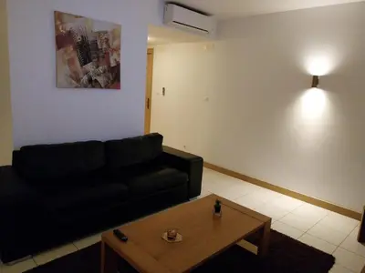 a living room with a black couch and a coffee table at Tity Apartments T1 - Perfect Stay on your Holiday in Santa Maria