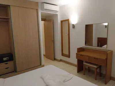 a bedroom with a bed and a desk and a mirror at Tity Apartments T1 - Perfect Stay on your Holiday in Santa Maria