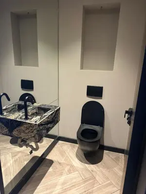 a bathroom with a sink and a toilet at Santiago Apartment in Mindelo