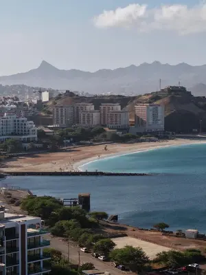 a view of a beach with buildings and the ocean at Santiago Apartment in Mindelo
