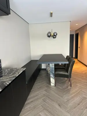 a dining room with a table and a chair at Santiago Apartment in Mindelo