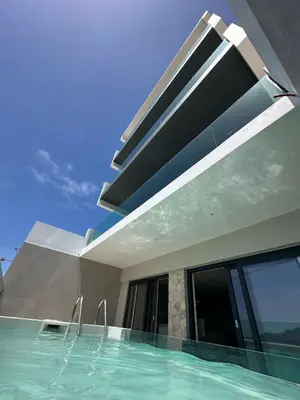 a swimming pool in front of a house at Sal Apartment in Mindelo