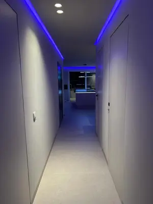 a corridor with blue lights in a hallway at Sal Apartment in Mindelo