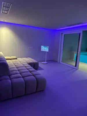 a purple room with a bed and a sign in it at Sal Apartment in Mindelo