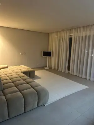 a bedroom with a large bed and a television at Sal Apartment in Mindelo