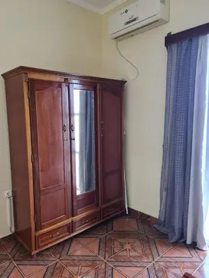 a wooden cabinet in the corner of a room at Djarfogo house in São Filipe