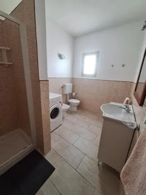 a bathroom with a toilet and a sink and a shower at Djadsal Moradias in Santa Maria