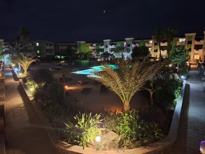 a view of a courtyard at night with buildings at Djadsal Moradias in Santa Maria