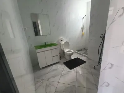 a bathroom with a toilet and a sink and a mirror at Casa Shell in Tarrafal