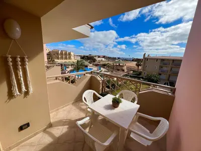 a balcony with a table and chairs and a view at Tropical Morna in Santa Maria