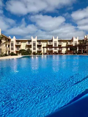 a large swimming pool in front of a resort at Tropical Morna in Santa Maria