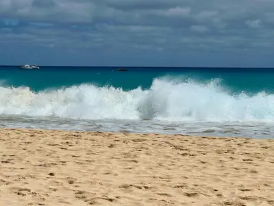 a wave in the ocean on a sandy beach at Tropical Morna in Santa Maria