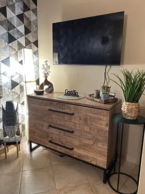 a television on top of a wooden dresser in a room at Tropical Morna in Santa Maria