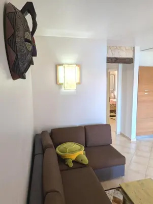 a living room with a couch with a yellow bowl on it at TOP POOL VIEW - Tropical Apt B11 - PointingCaboVerde in Santa Maria